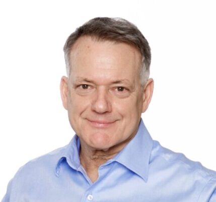 A man in blue shirt and white background